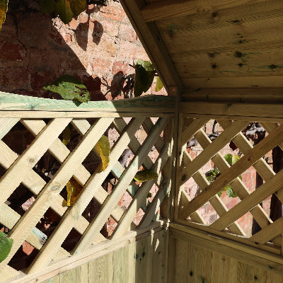 A wooden/timber garden trellis structure with a lattice design, The light natural wood panels and diagonal crisscross lattice