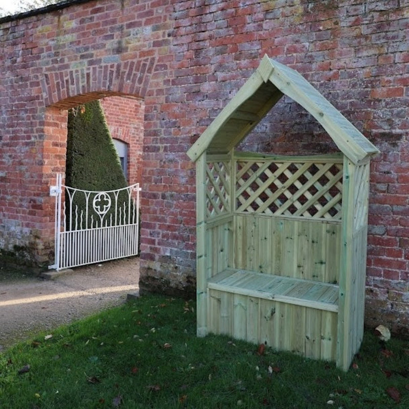 A small wooden garden bench shelter with a pitched roof and lattice back panel